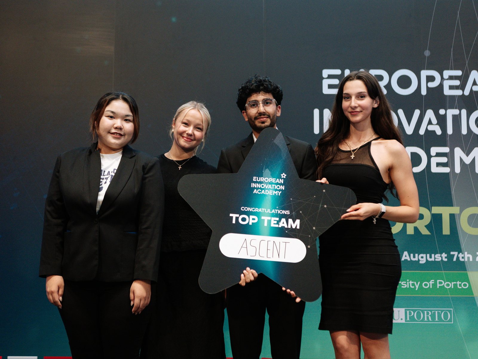 The Ascent team on stage at the European Innovation Academy in Porto, holding a star-shaped Top Team sign with Ascent written on it